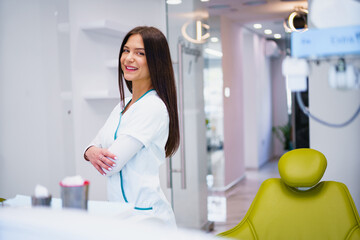 Portrait of female dentist .She standing in her dentist office.