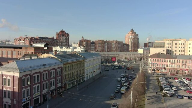 Busy automobile traffic on the roads of Tula among modern buildings. Shooting from above by drone.