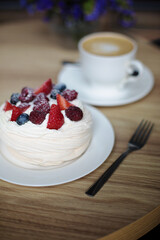 Pavlova dessert with a cup of coffee