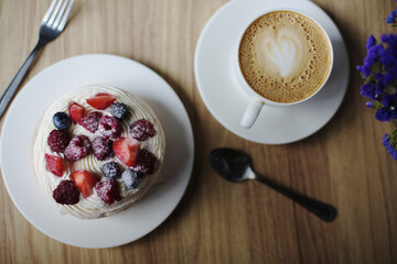 Pavlova dessert with a cup of coffee