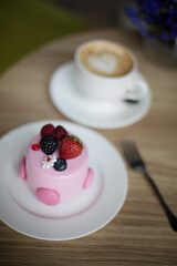 Pink desserts with berries on a table