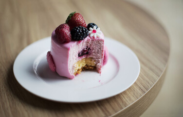 Pink desserts with berries on a table
