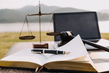 Judge gavel and legal book on wooden table, justice and law concept
