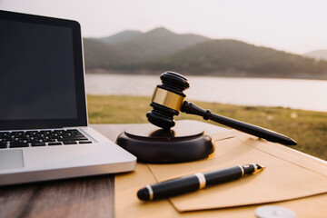 Judge gavel and legal book on wooden table, justice and law concept