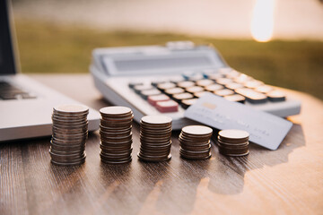 Credit bank card, money and coins on the home wood table, with selective focus, soft light and vintage filter, business concept