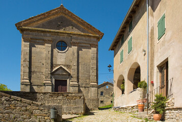 Fototapeta na wymiar The Parish Church of the Assumption of Mary in the village of Hum in Istria, Croatia. This church with a classical facade was built in 1802 