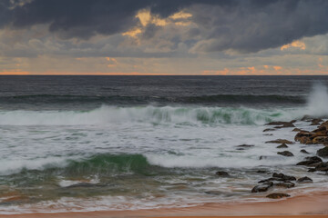 Overcast sunrise seascape with rain clouds