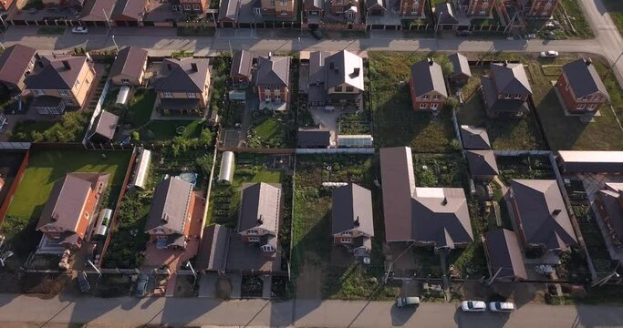 Aerial view of a luxurious village with smooth rows of two-storey duplex houses. Neighborhood in the area and real estate investments.