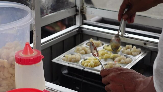 the process of making cilor, which is a typical Indonesian street food