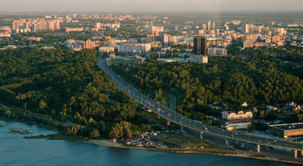 Fototapeta na wymiar Summer shot from above of Kazan city. Capital of the Tatarstan, Russia. City centre and landmark. Bridge and attractions. Torism and tourist destination. Gorky park. Trees and vacation in the city.