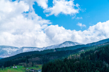 Fototapeta premium Germany, Magical black forest panorama view above beautiful nature landscape in springtime, snow covered mountains