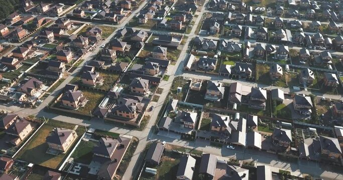 Aerial view of a luxurious village with smooth rows of two-storey duplex houses. Neighborhood in the area and real estate investments.