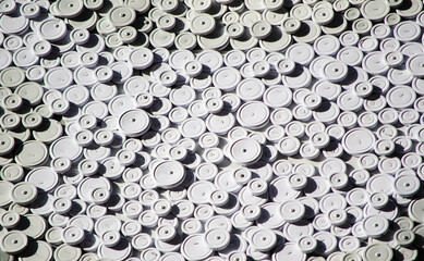 A heap of White plastic Circle set up into abstract pattern for background.
