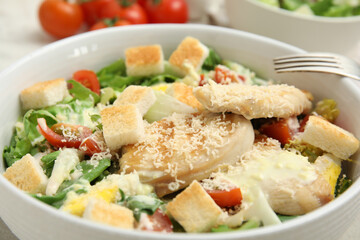 Delicious Caesar salad in bowl, closeup view