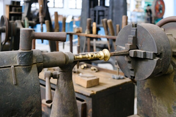 Interior of an old metalworking factory with metal lathes and presses.