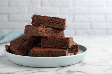 Delicious chocolate brownies on white marble table