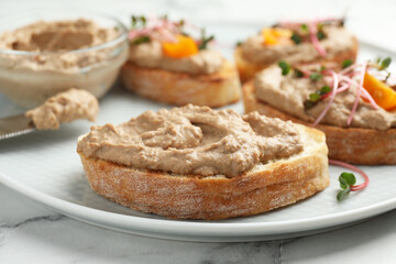 Slices of bread with delicious pate on white marble table, closeup