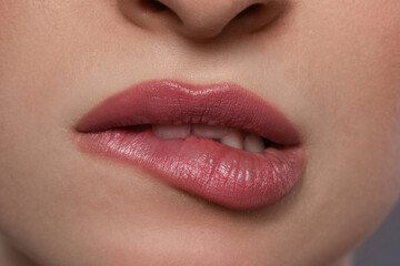 Young woman with beautiful plump lips, closeup