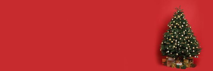 Beautifully decorated Christmas tree and gift boxes on red background, space for text. Banner design