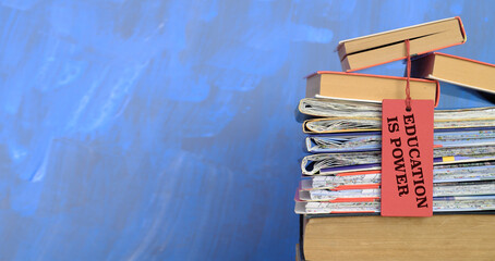 stack of books and slogan education is power,learning,education,back to school concept