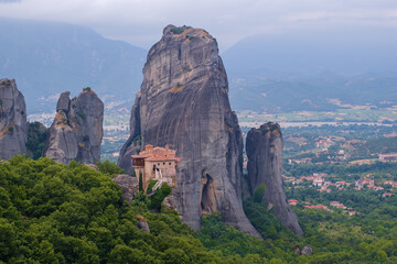 Fototapeta na wymiar View of Monastery of Rousanou on top of a sheer cliff. The miracle of Meteora - harmony of man and nature in Greece. A popular travel and pilgrimage destination