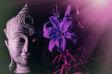 Zen Concept - Buddha face in mindful meditation with flower. Nature and wellbeing.