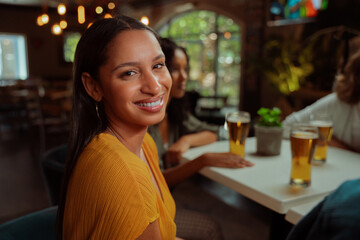 african american female smiling while enjoying evening with friends