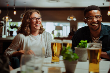 diverse friends out for dinner drinking beers 