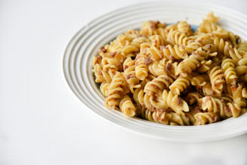 Boiled vermicelli with meat in navy style on a plate