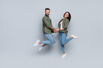 Full size photo of romance married lady guy jump hold hands travel honeymoon isolated grey color...