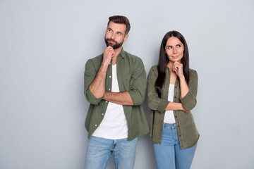 Photo of young husband wife think plan minded look empty space wonder trust isolated over grey color background