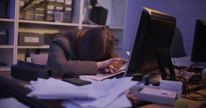 A young woman fell asleep at the table in the office, then she wakes up and stands on the phone. Slow motion 4k footage