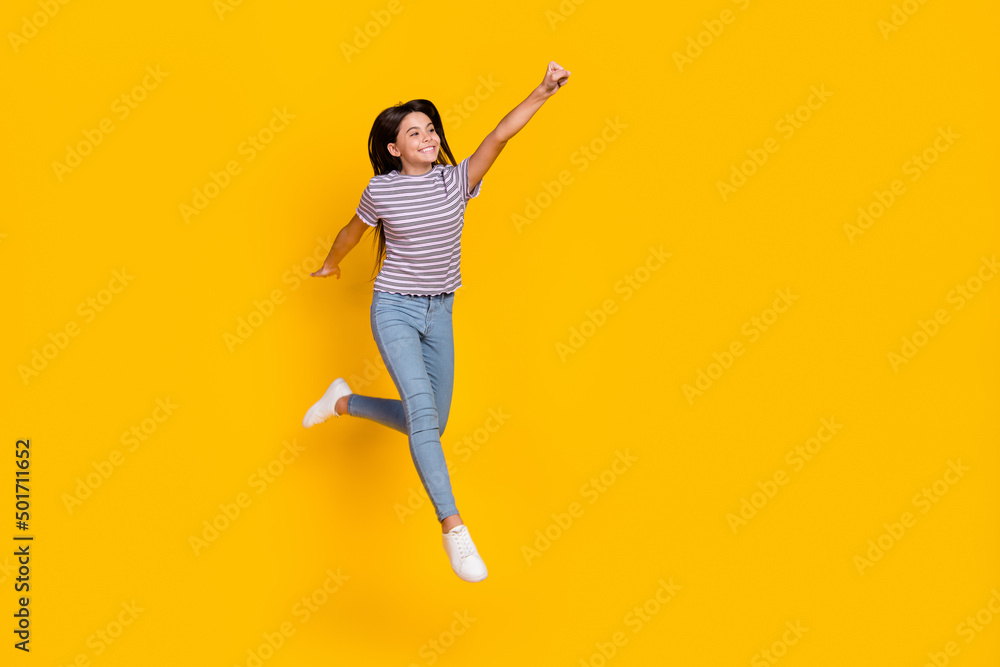 Sticker Full size photo of young cheerful girl jump fly power look empty space isolated over yellow color background