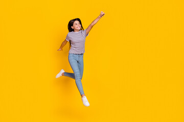 Fototapeta na wymiar Full size photo of young cheerful girl jump fly power look empty space isolated over yellow color background