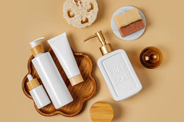 Cosmetic bottles on wooden tray, soap and washcloths. Eco cosmetics products and accessories. Natural skincare beauty product concept.