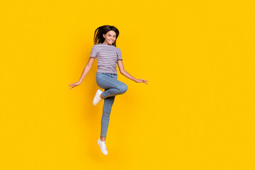 Fototapeta na wymiar Full length photo of young lovely cheerful girl jumper dream travel isolated over yellow color background