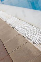 Obraz na płótnie Canvas Tiled floor near swimming pool. Closeup. Selective focus.
