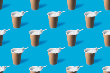 A repeating pattern of a cup of coffee and white creamy ice cream on a blue background