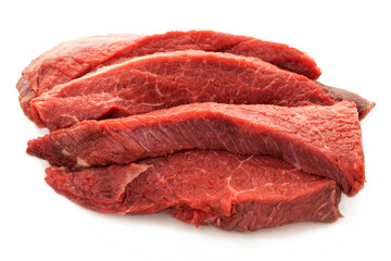 A piece of fresh red beef is cut into several pieces. Conceptual. Isolated on white background.