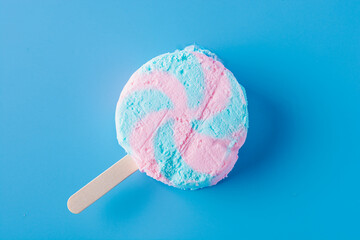 Briquette of round popsicles on a stick on a blue background