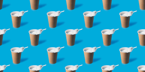 A repeating pattern of a cup of coffee and white creamy ice cream on a blue background
