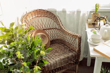 wicker chair in the spring on the veranda - obrazy, fototapety, plakaty
