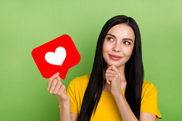 Photo of dreamy funky lady dressed yellow t-shirt holding heart like sign empty space isolated green color background