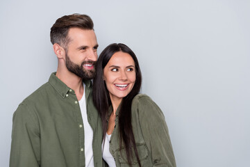 Profile side photo of young cheerful spouses romantic interested look empty space isolated over grey color background