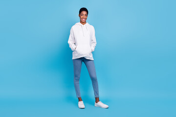 Photo of charming pretty unisex lady dressed white hoodie walking isolated blue color background