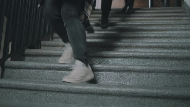 A team of IT developers running down the stairs to the bomb shelter due to the bombing during the war
