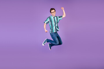 Fototapeta na wymiar Full body profile side photo of young man jumper rejoice victory success isolated over violet color background