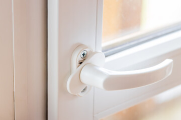 woman adjusting white pvc plastic balcony window door indoors. female using screwdriver to repair...