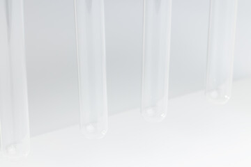 medical or scientific empty glass tubes on white stand. laboratory rack with sample vials. copy space