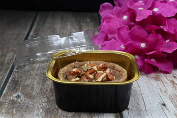 Mock up of Chocolate Keto cake topping with sliced almond serving in the plastic box. Famous healthy dessert product.